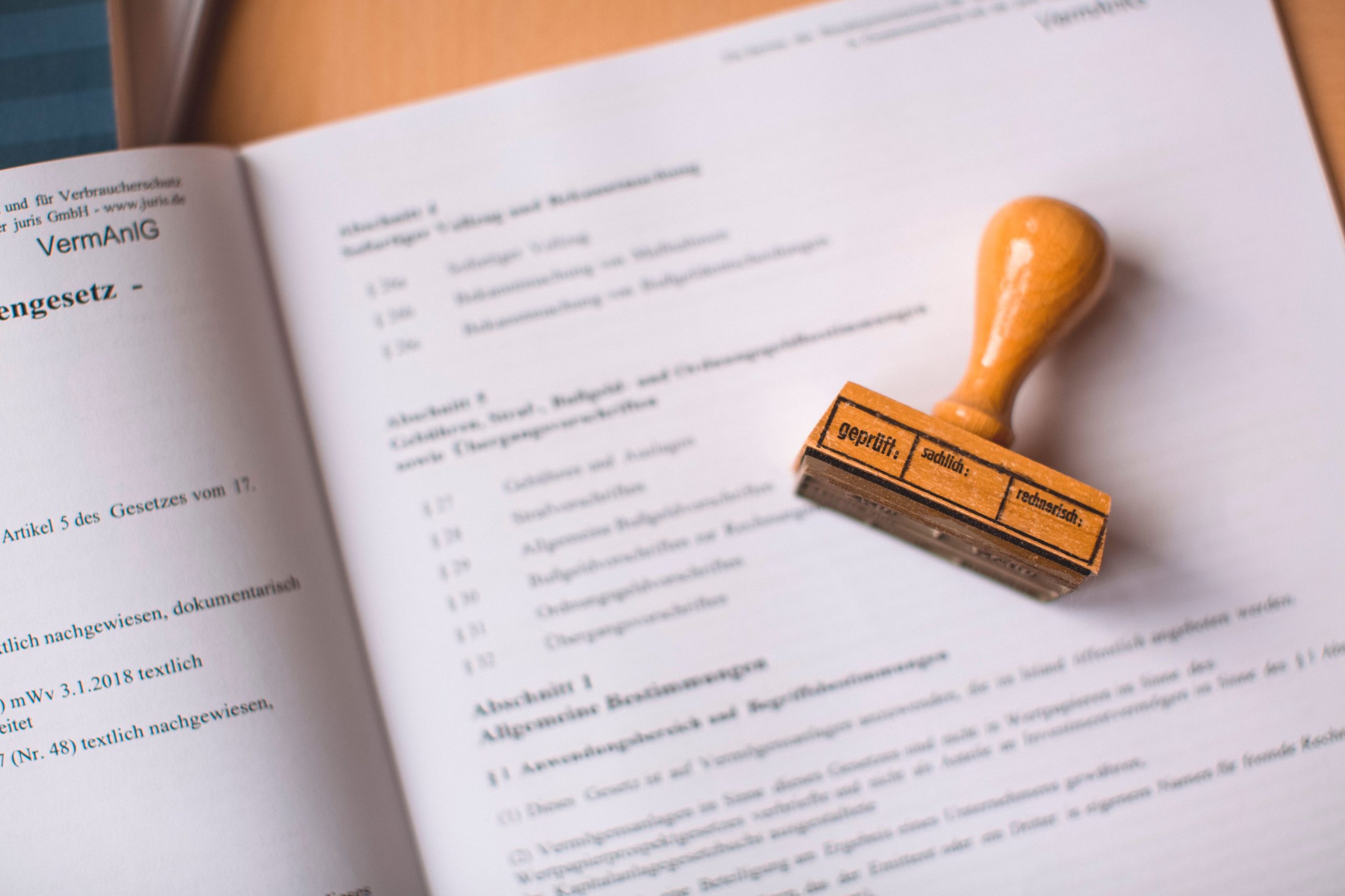 Close-up of a legal document with a wooden stamp on top, illustrating the filing stage of a complex litigation case