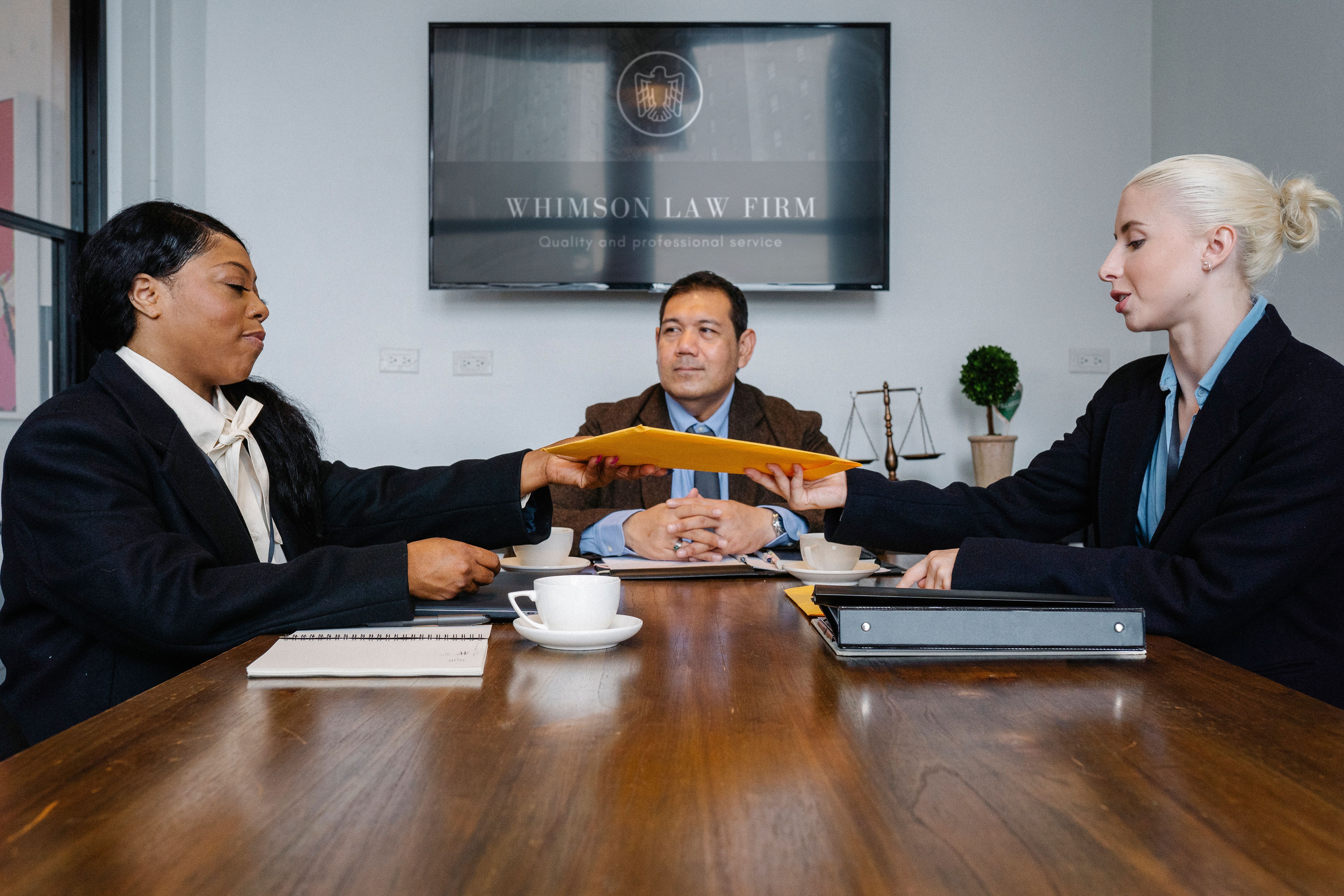 Diverse legal team discussing a court decision and settlement options around a table